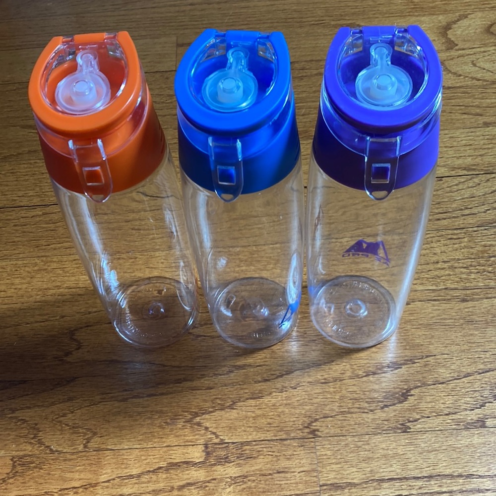 3 Az Pro water bottles, orange, navy and purple.